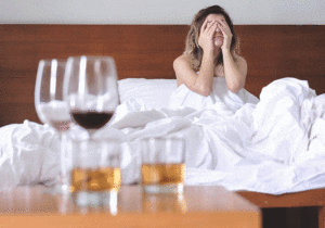 Woman-In-Bed-With-Hangover-Wine-Glasses-Hard-Alcohol-THC-CBDA-CBD-CBGA-May-Help
