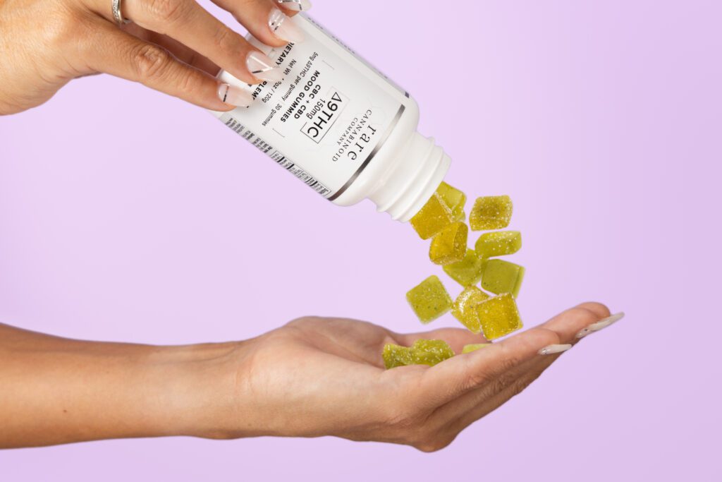 Woman pours Rare Cannabinoid Company Delta-9-THC Gummies with CBC and CBD into her hand.
